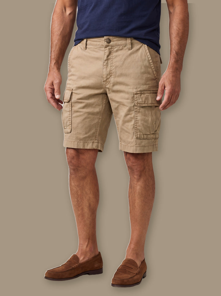 Leander summer shorts in Sand, worn by a model on a warm taupe studio background - Gentlemens Manor
