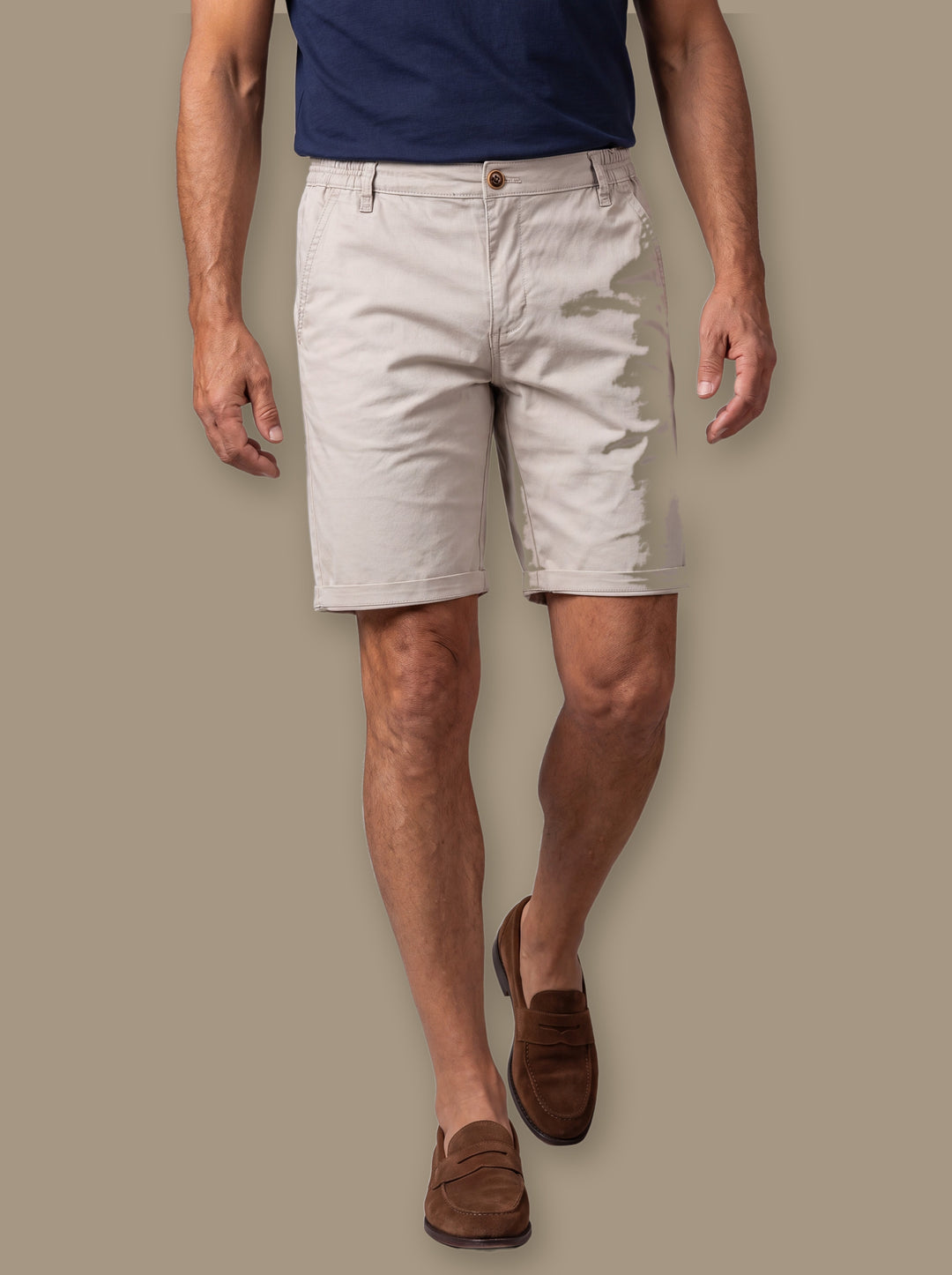 Leland summer shorts in Sand, worn by a model on a warm taupe studio background - Gentlemens Manor