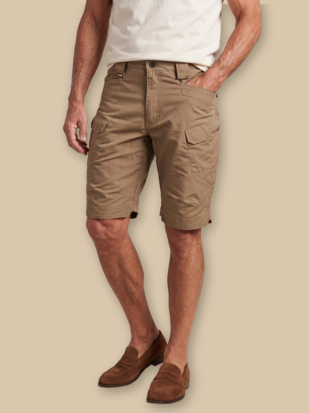 Leopold summer shorts in Brown, worn by a model on a warm sand studio background - Gentlemens Manor