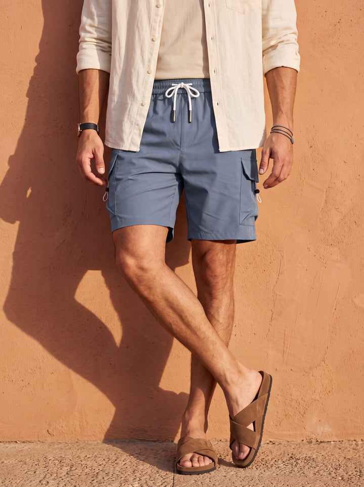 Leroy Men summer shorts in blue, worn by a model in a Mediterranean setting - Gentlemens Manor lifestyle