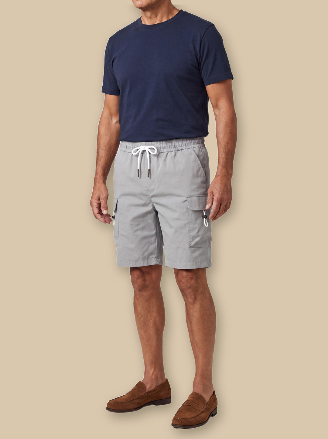 Leroy summer shorts in Grey, worn by a model on a warm sand studio background - Gentlemens Manor