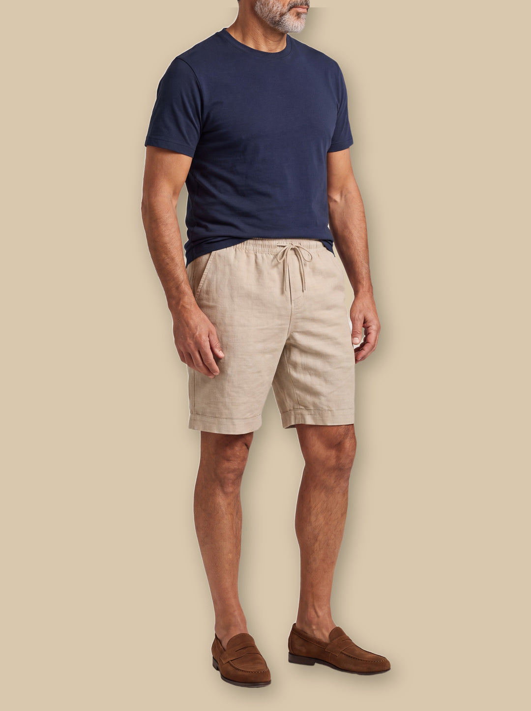 Lincoln summer shorts in Sand, worn by a model on a warm sand studio background - Gentlemens Manor