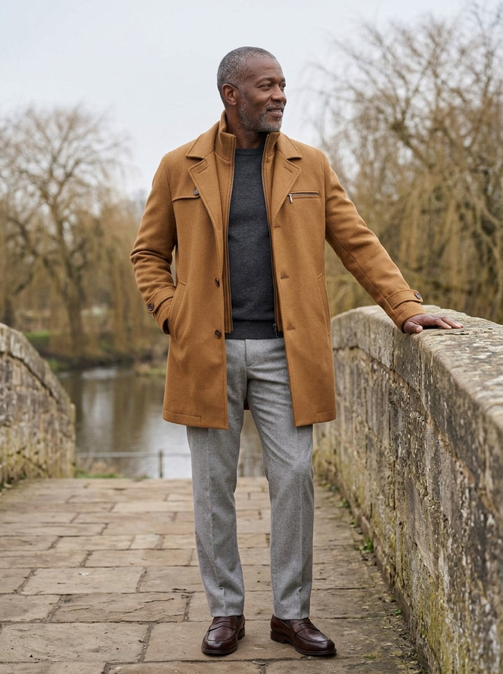 Lockhart coat in Camel, lifestyle on a stone footbridge, Gentlemens Manor