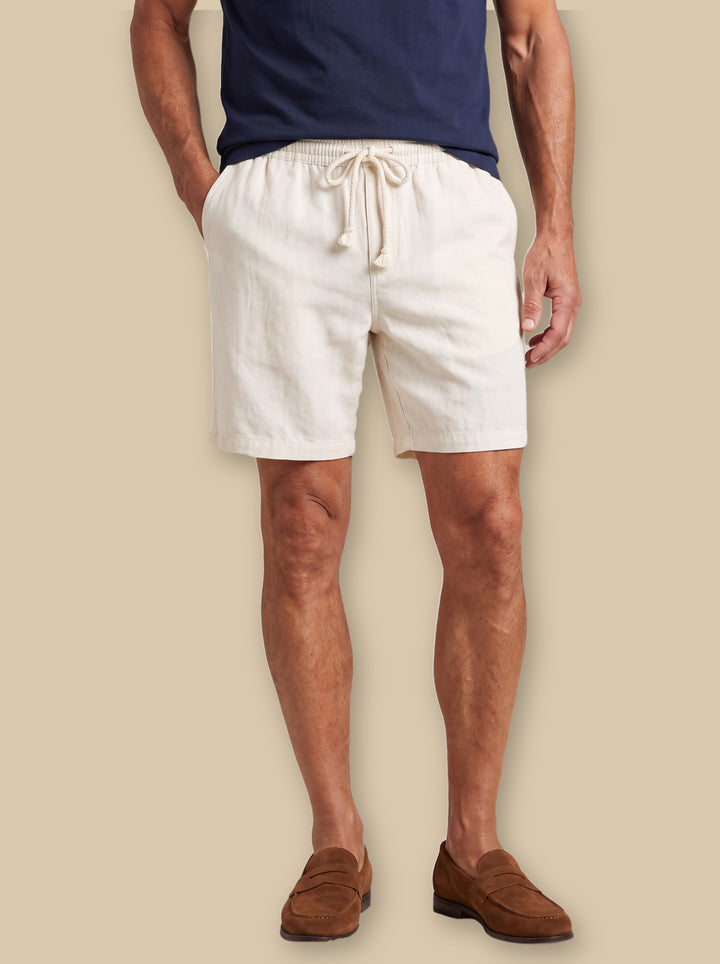 Logan summer shorts in White, worn by a model on a warm sand studio background - Gentlemens Manor