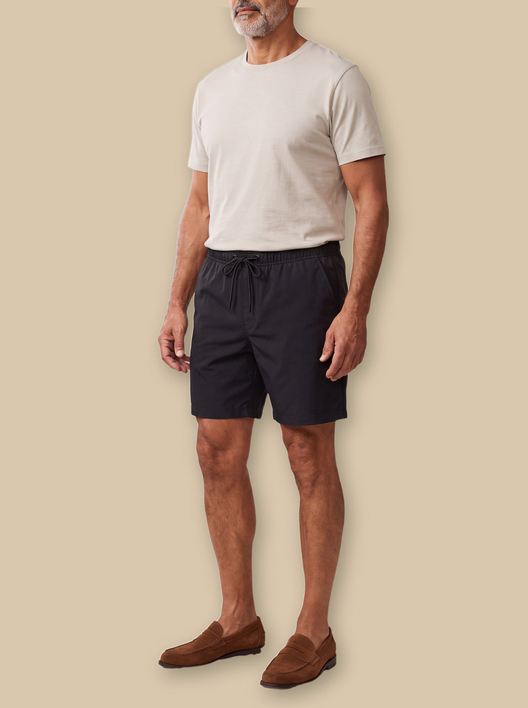 Lonnie summer shorts in Black, worn by a model on a warm sand studio background - Gentlemens Manor
