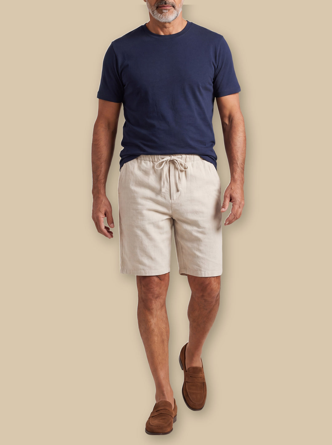 Lorenzo summer shorts in Sand, worn by a model on a warm sand studio background - Gentlemens Manor