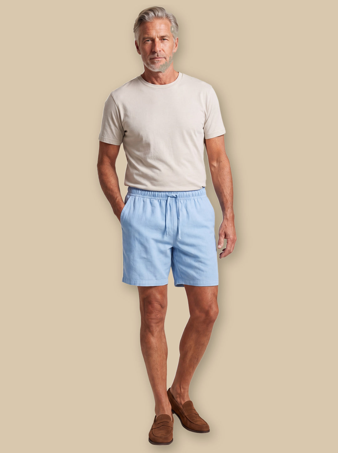 Lowell summer shorts in Blue, worn by a model on a warm sand studio background - Gentlemens Manor