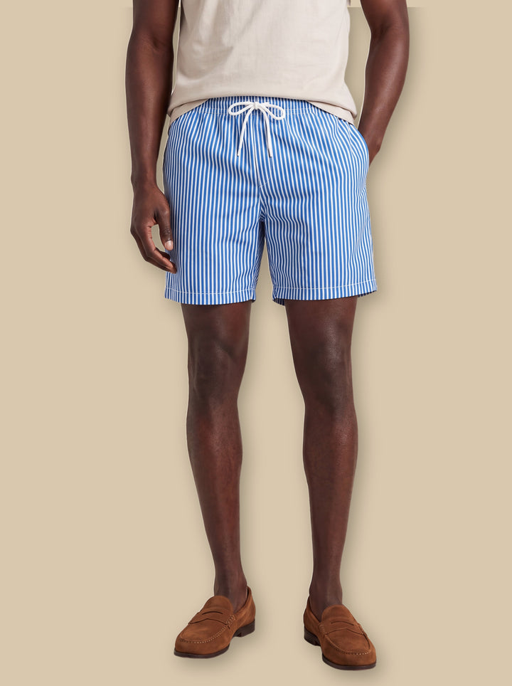 Luther summer shorts in Blue, worn by a model on a warm sand studio background - Gentlemens Manor