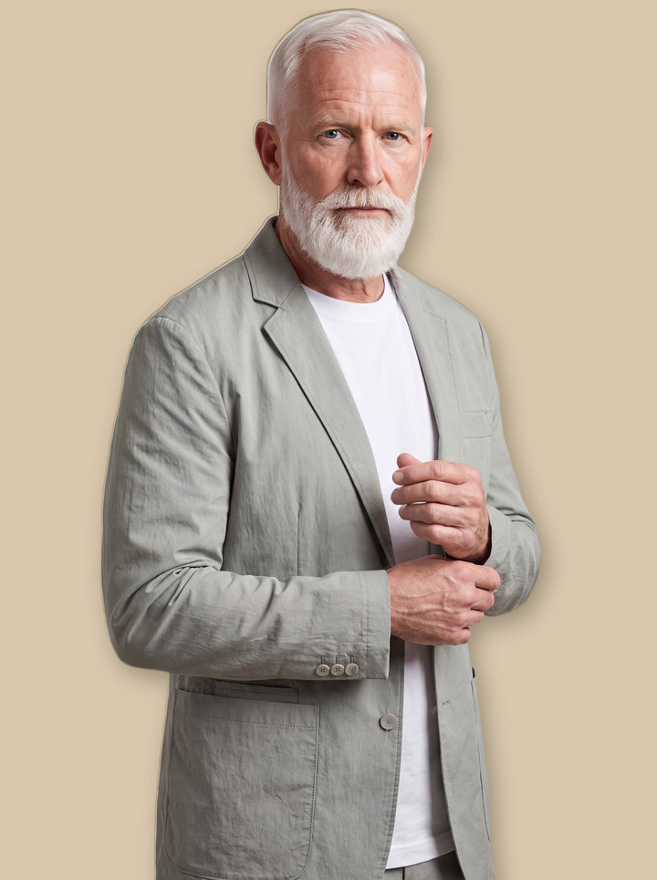 Malcolm blazer suit in Sage, worn by a model on a warm sand studio background - Gentlemens Manor
