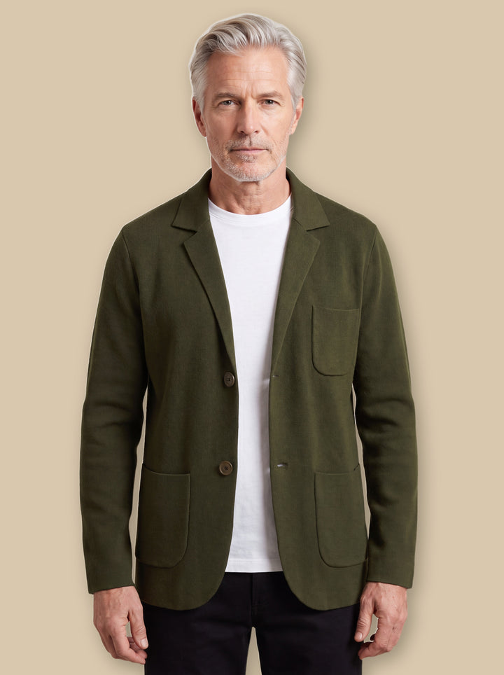 Martin blazer suit in Olive, worn by a model on a warm sand studio background - Gentlemens Manor