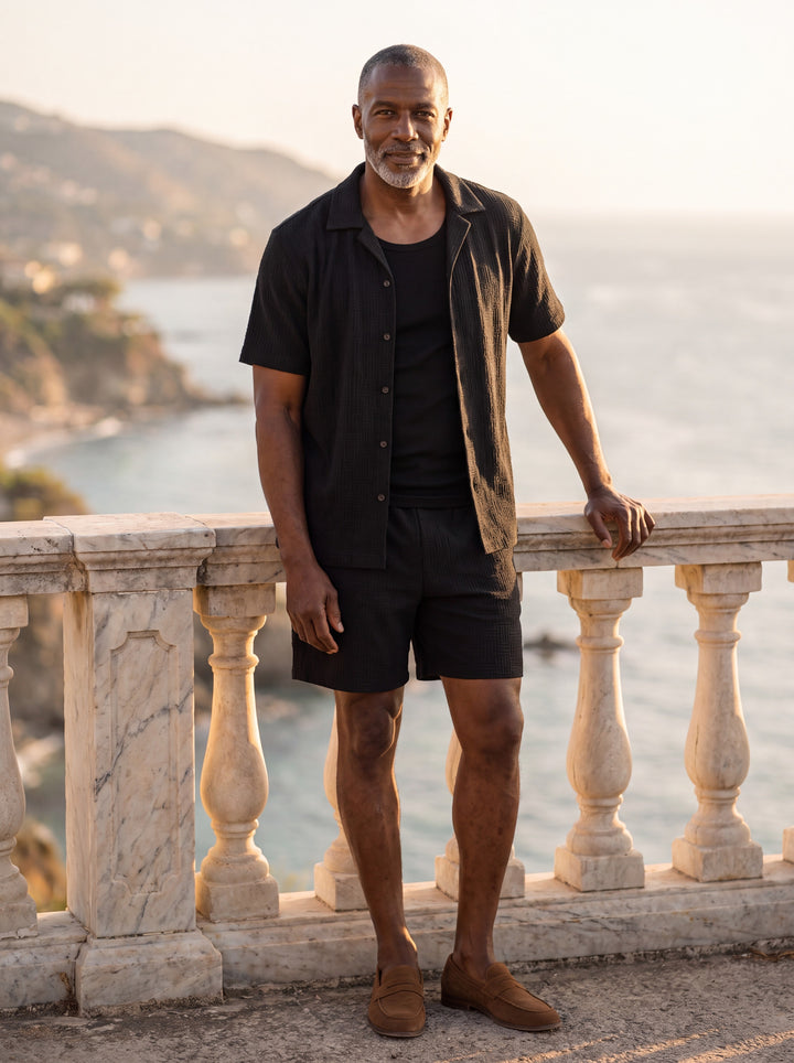Maxwell Men two piece set in black, worn by a model on a Mediterranean terrace - Gentlemens Manor lifestyle