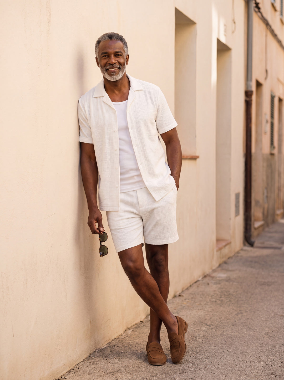Maxwell Men two piece set in white, worn by a model on a Mediterranean terrace - Gentlemens Manor lifestyle