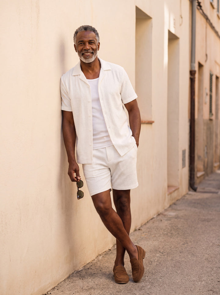Maxwell Men two piece set in white, worn by a model on a Mediterranean terrace - Gentlemens Manor lifestyle