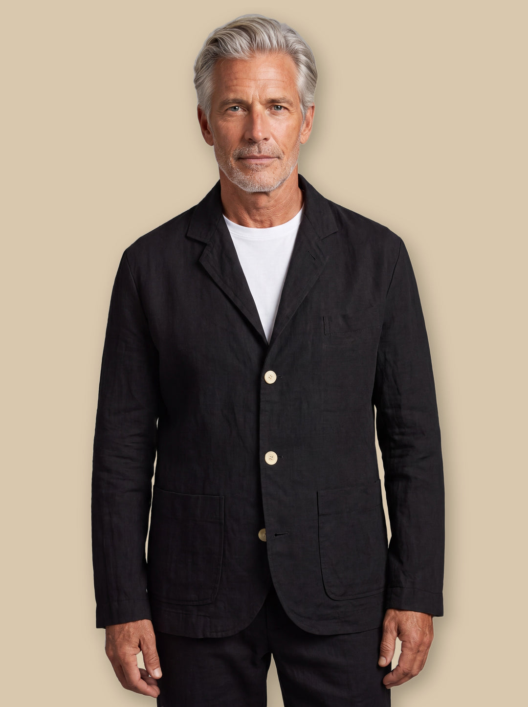 Merle blazer suit in Black, worn by a model on a warm sand studio background - Gentlemens Manor
