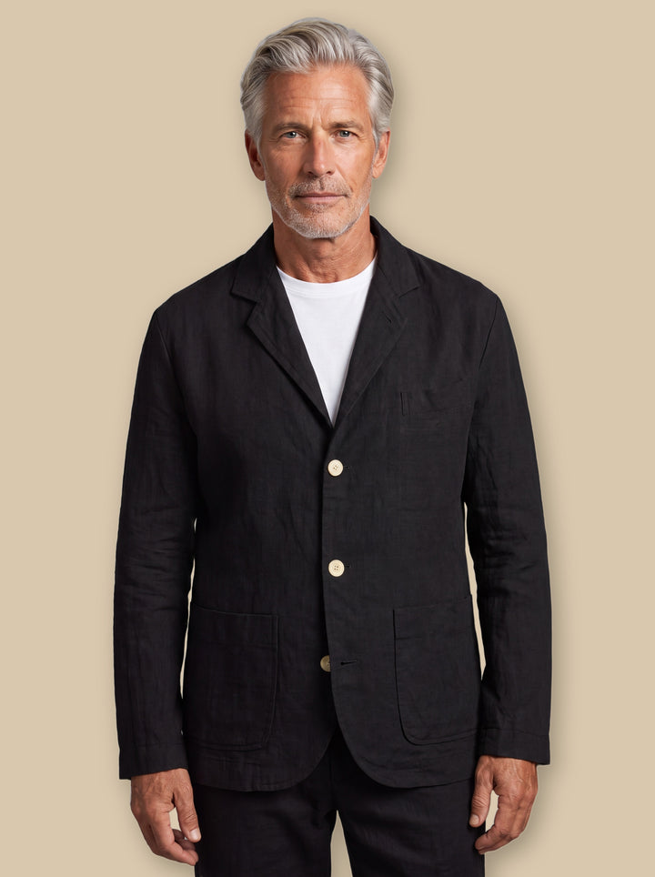 Merle blazer suit in Black, worn by a model on a warm sand studio background - Gentlemens Manor