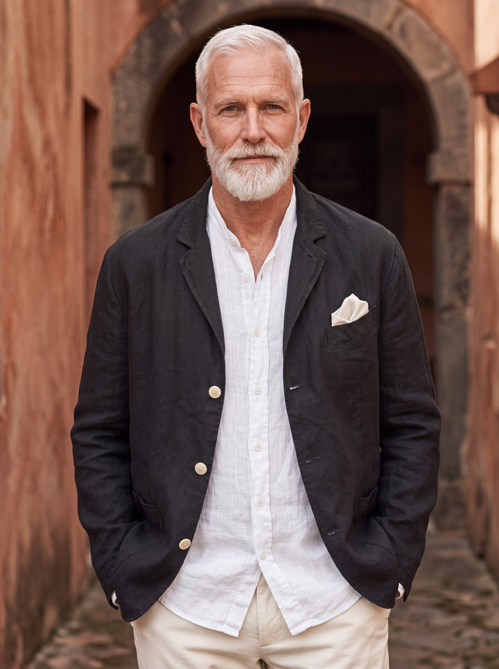 Merle blazer in Black, worn by a model in a Mediterranean setting - Gentlemens Manor lifestyle