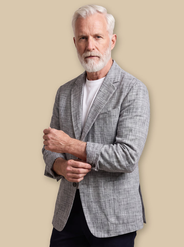 Mortimer blazer suit in Grey, worn by a model on a warm sand studio background - Gentlemens Manor