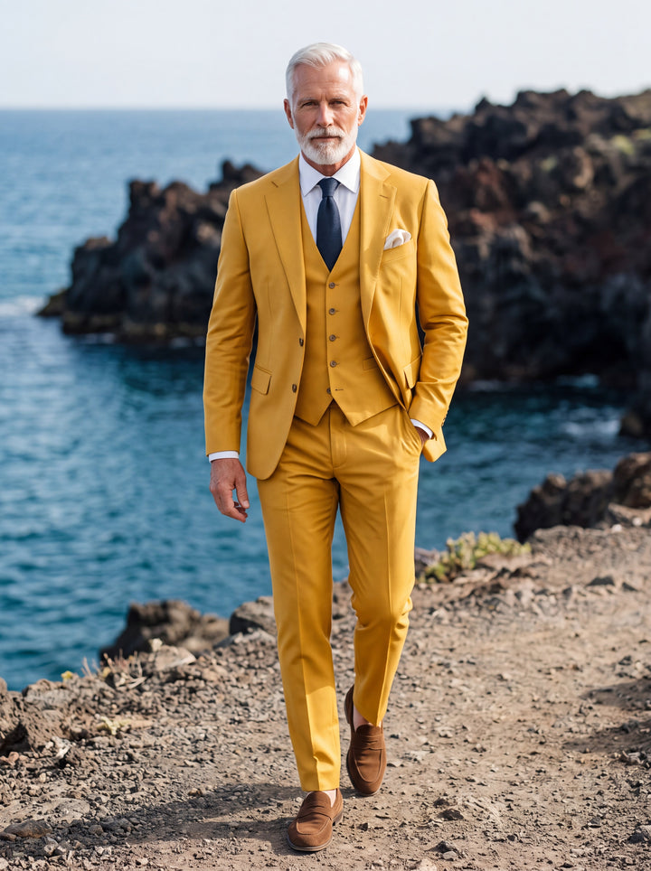 Morton Men three-piece suit in mustard, worn by a model in a Mediterranean setting - Gentlemens Manor lifestyle