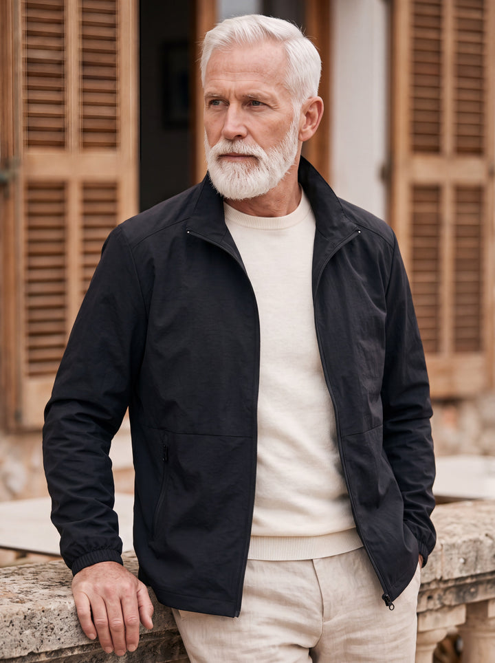 Moses jacket in Black, worn by a model in a Mediterranean setting - Gentlemens Manor lifestyle