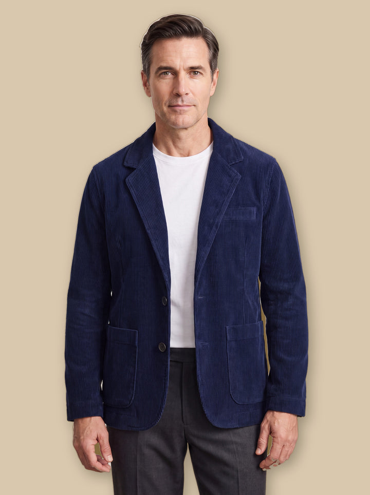 Murray jacket in Navy, worn by a model on a warm sand studio background - Gentlemens Manor