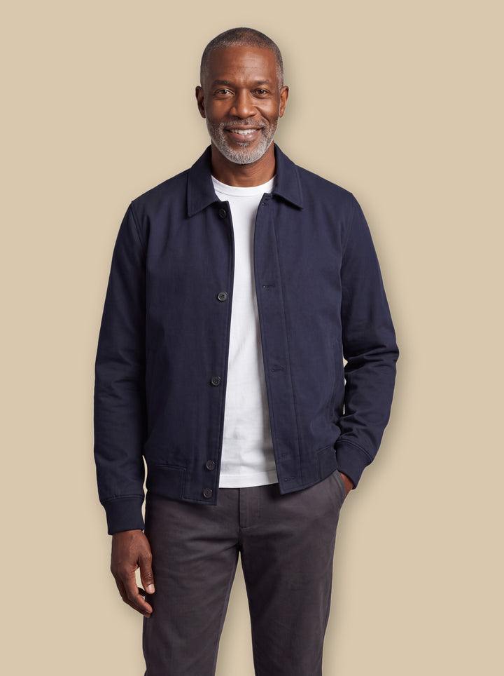 Myron jacket in Navy, worn by a model on a warm sand studio background - Gentlemens Manor