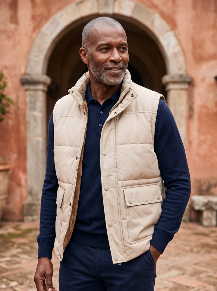 Ned vest in Sand, worn by a model in a Mediterranean setting - Gentlemens Manor lifestyle