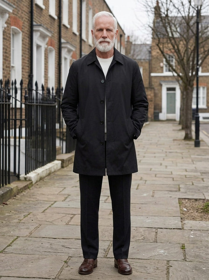 Newell mid length mac coat in Black, lifestyle on a street of brick row houses, Gentlemens Manor