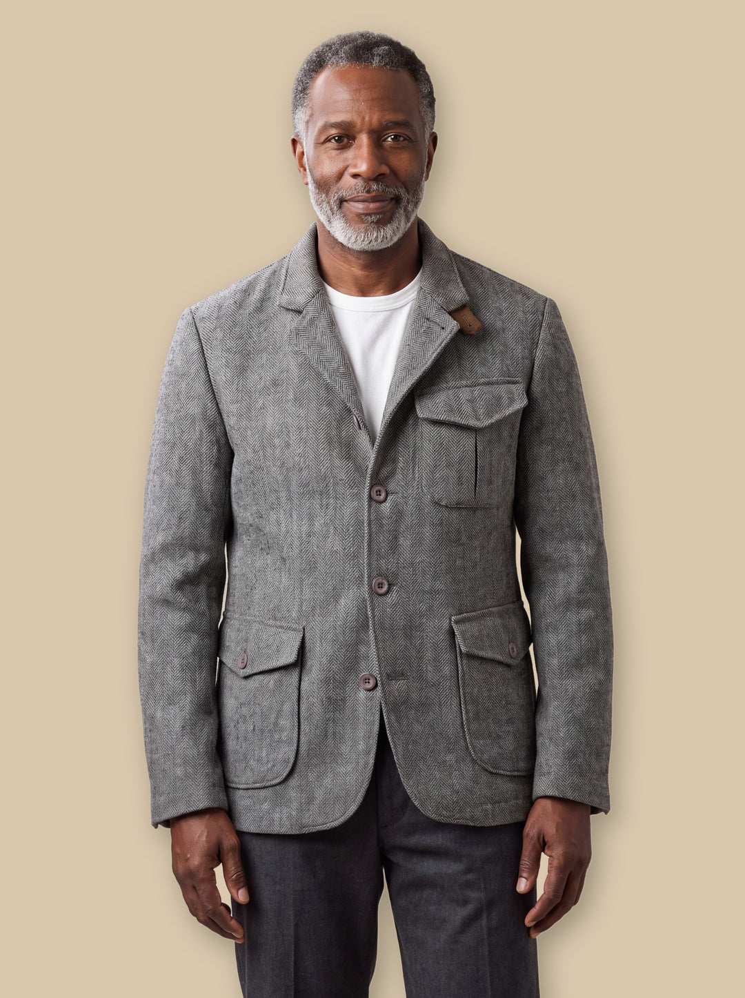 Newton jacket in Light Grey, worn by a model on a warm sand studio background - Gentlemens Manor