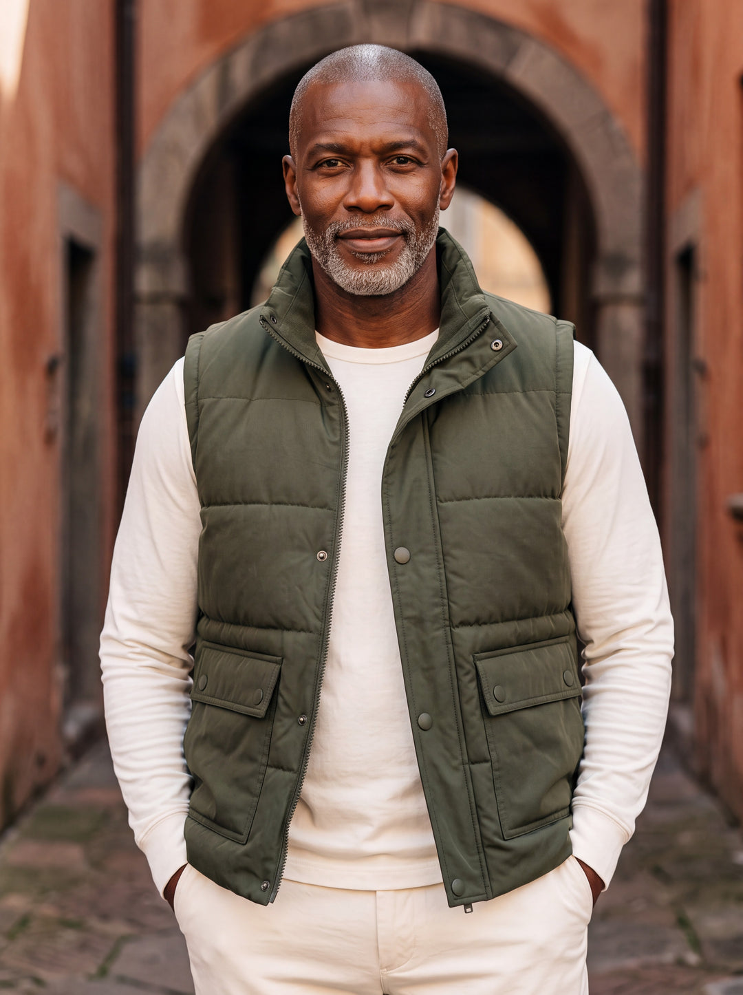 Nigel vest in Olive, worn by a model in a Mediterranean setting - Gentlemens Manor lifestyle