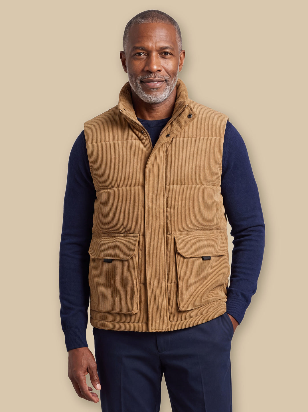 Noble vest in Sand, worn by a model on a warm sand studio background - Gentlemens Manor