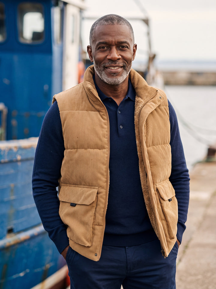 Noble vest in Sand, worn by a model in a Mediterranean setting - Gentlemens Manor lifestyle
