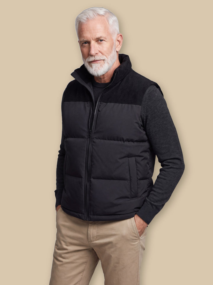 Norbert vest in Black, worn by a model on a warm sand studio background - Gentlemens Manor