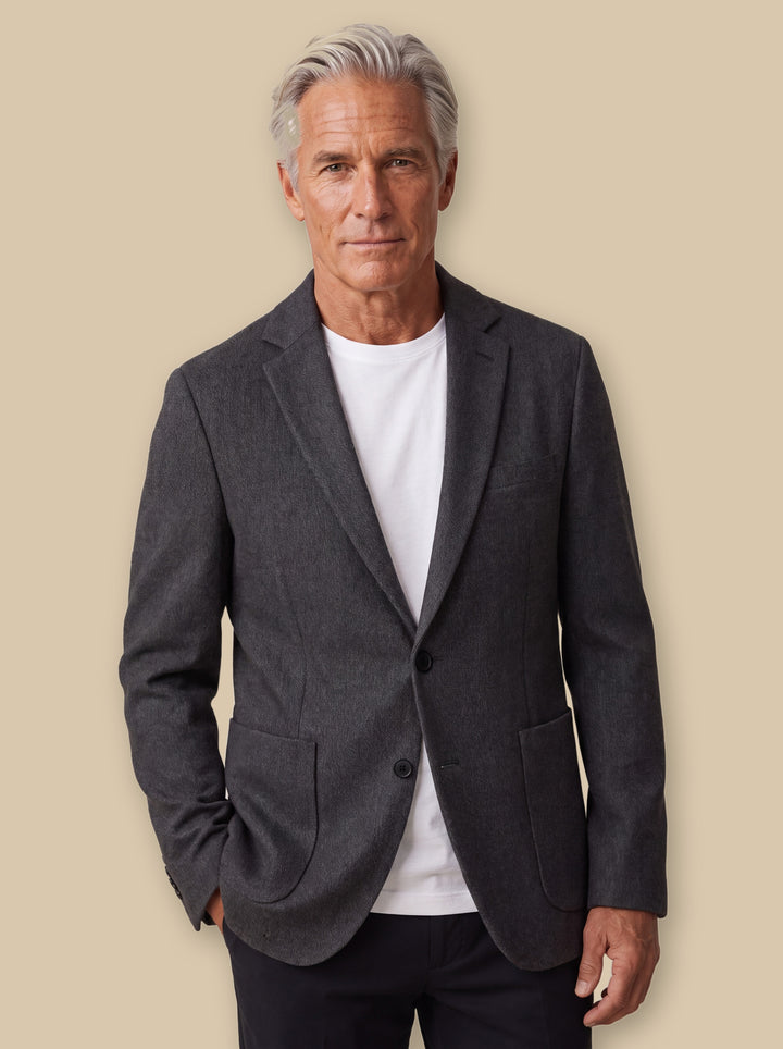 Norman blazer suit in Grey, worn by a model on a warm sand studio background - Gentlemens Manor