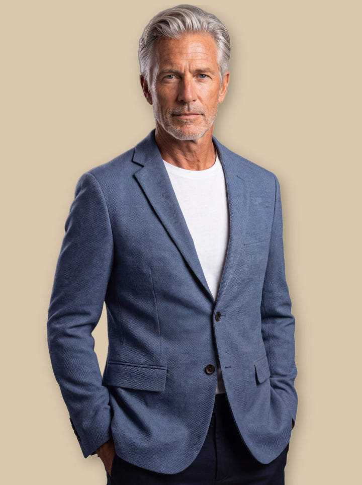 Oakley blazer suit in Blue, worn by a model on a warm sand studio background - Gentlemens Manor