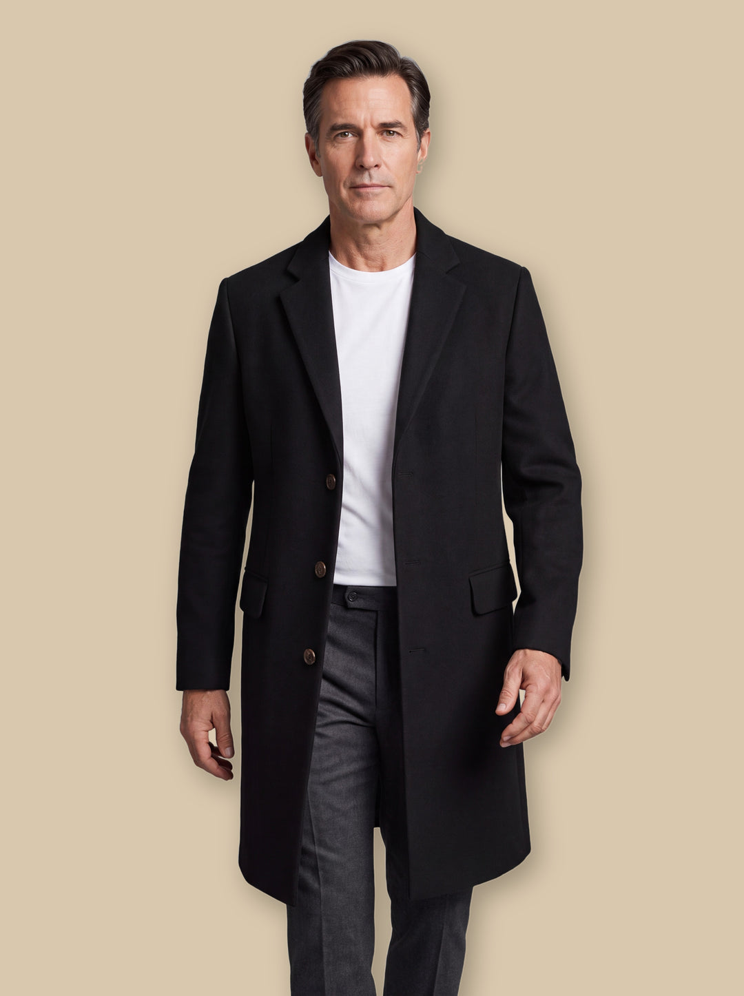 Oliver jacket in Black, worn by a model on a warm sand studio background - Gentlemens Manor