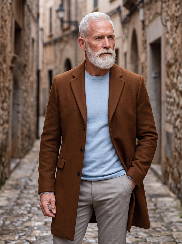 Oliver coat in Brown, worn by a model in a Mediterranean setting - Gentlemens Manor lifestyle