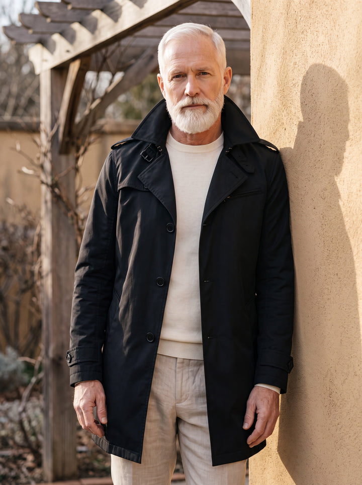 Oran coat in Black, worn by a model in a Mediterranean setting - Gentlemens Manor lifestyle