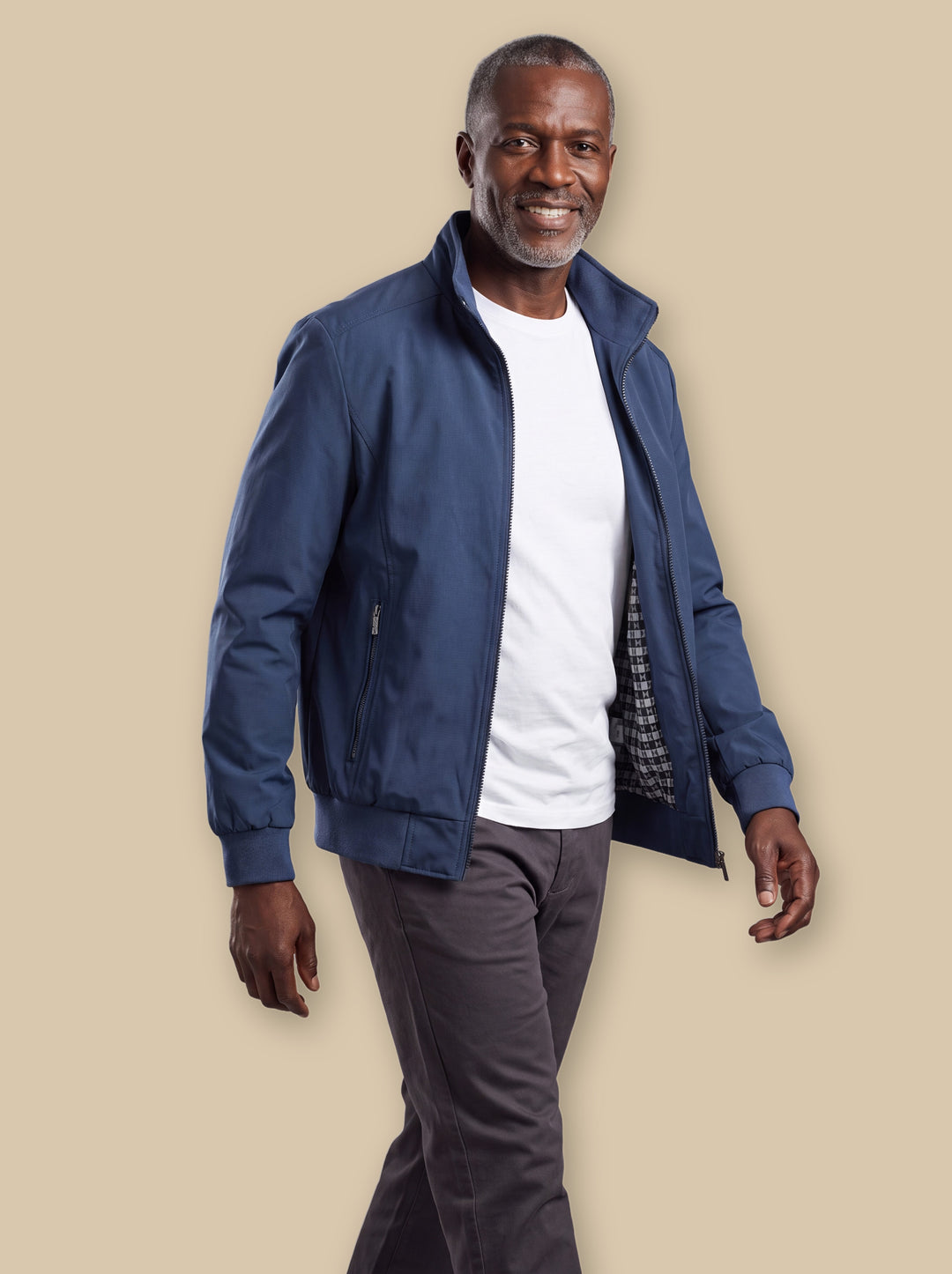 Orville jacket in Blue, worn by a model on a warm sand studio background - Gentlemens Manor