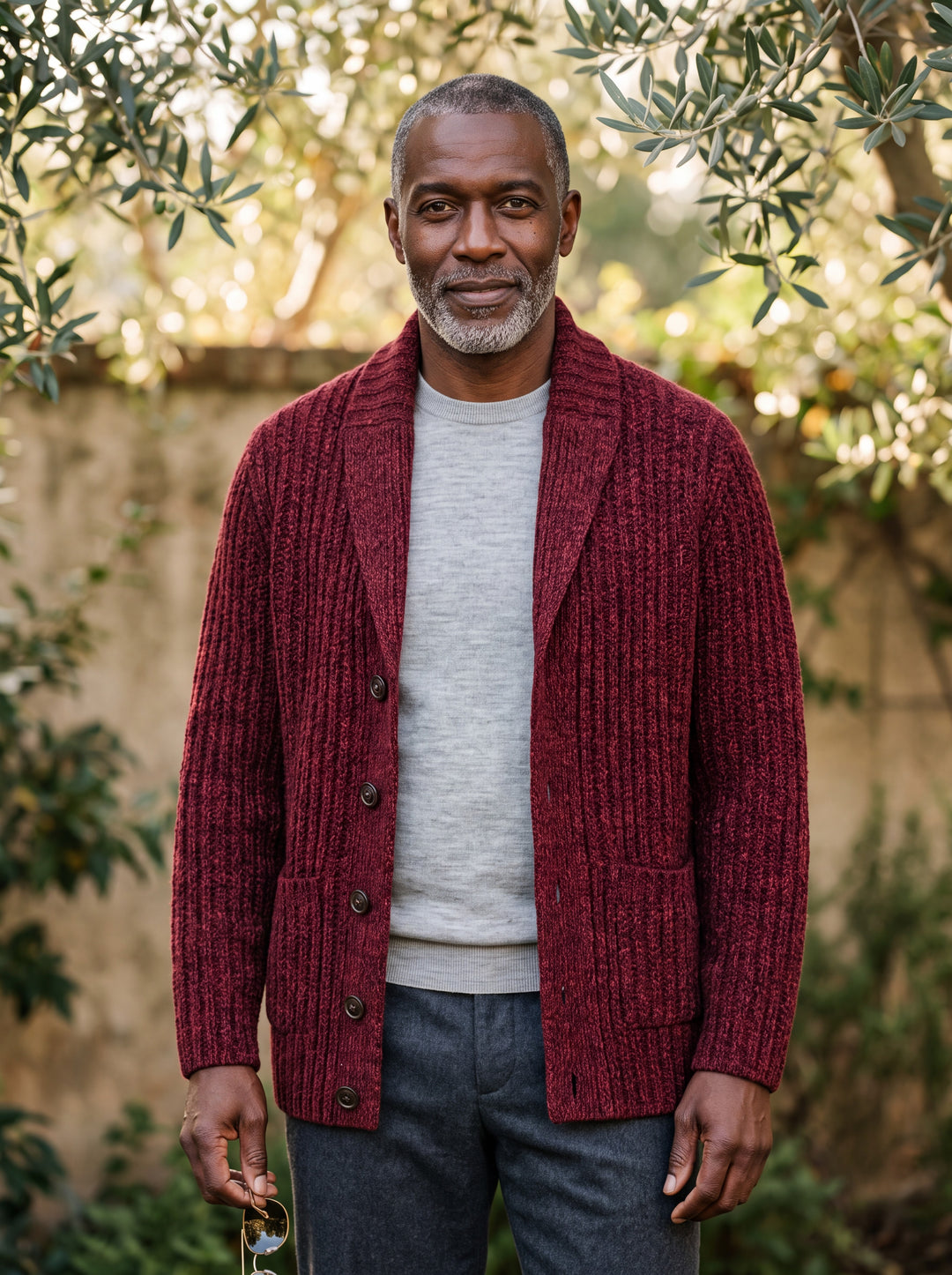 Oscar cardigan in Burgundy, worn by a model in a Mediterranean setting - Gentlemens Manor lifestyle