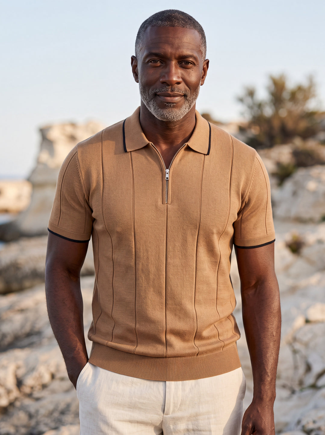 Osmond Men polo shirt in brown, worn by a model on a Mediterranean terrace - Gentlemens Manor lifestyle