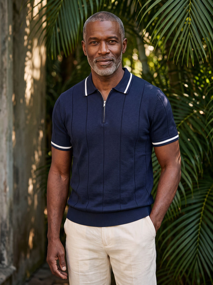 Osmond Men polo shirt in navy, worn by a model on a Mediterranean terrace - Gentlemens Manor lifestyle