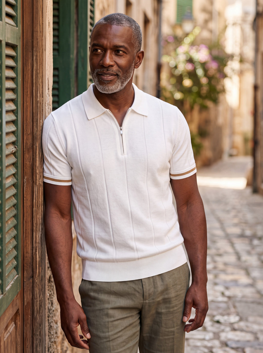 Osmond Men polo shirt in white, worn by a model on a Mediterranean terrace - Gentlemens Manor lifestyle