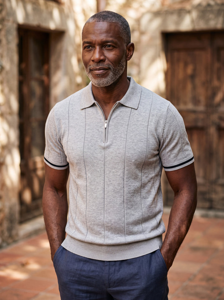 Otis Men polo shirt in light grey, worn by a model on a Mediterranean terrace - Gentlemens Manor lifestyle