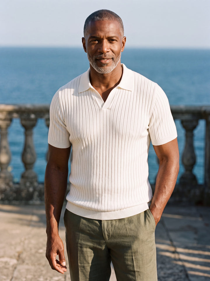 Owen Men polo shirt in white, worn by a model on a Mediterranean terrace - Gentlemens Manor lifestyle