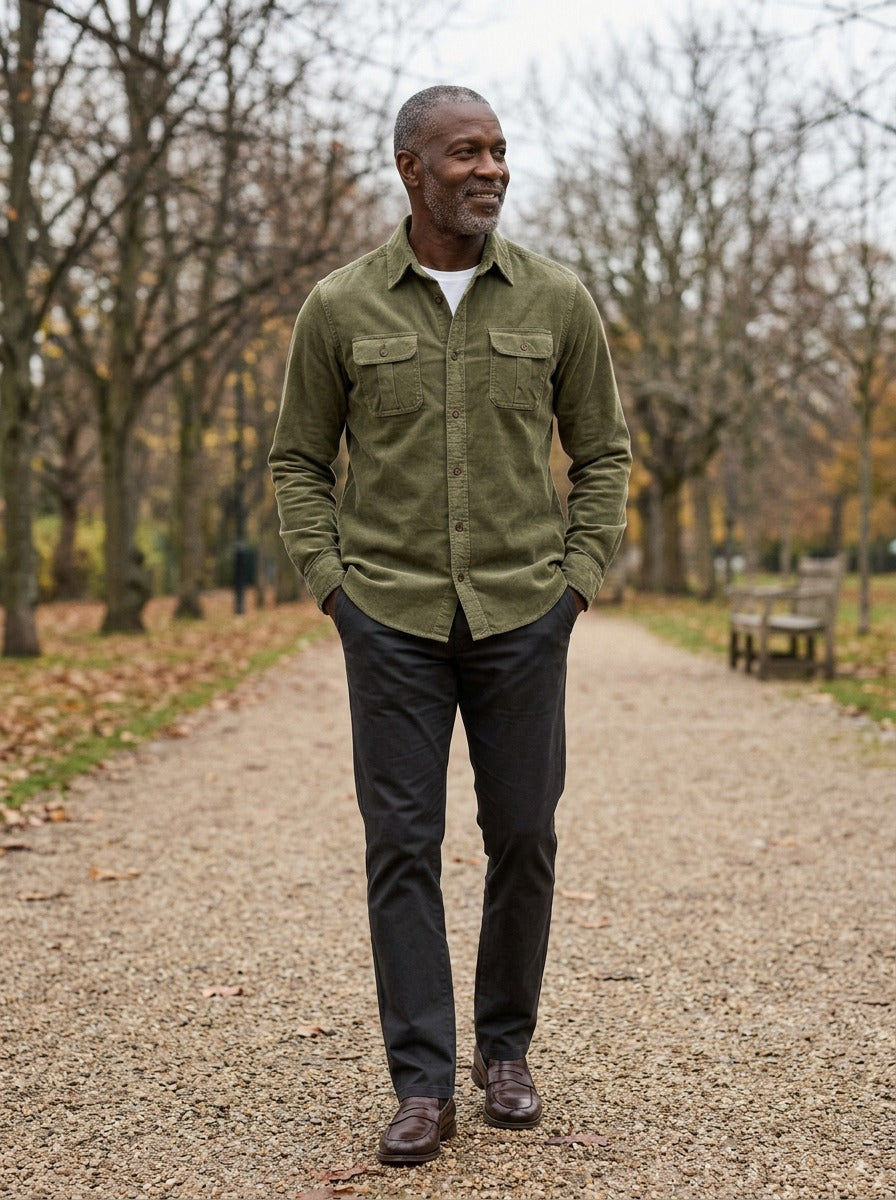 Packard corduroy flap pocket overshirt in Olive, lifestyle on a park path, Gentlemens Manor