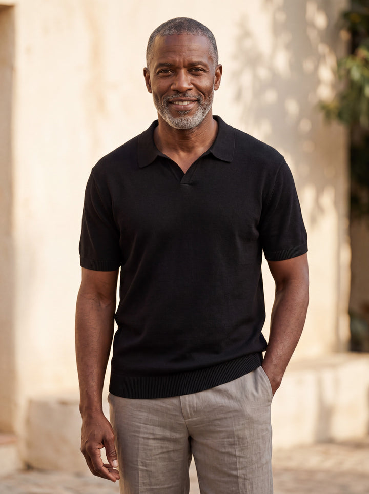 Palmer Men polo shirt in black, worn by a model on a Mediterranean terrace - Gentlemens Manor lifestyle