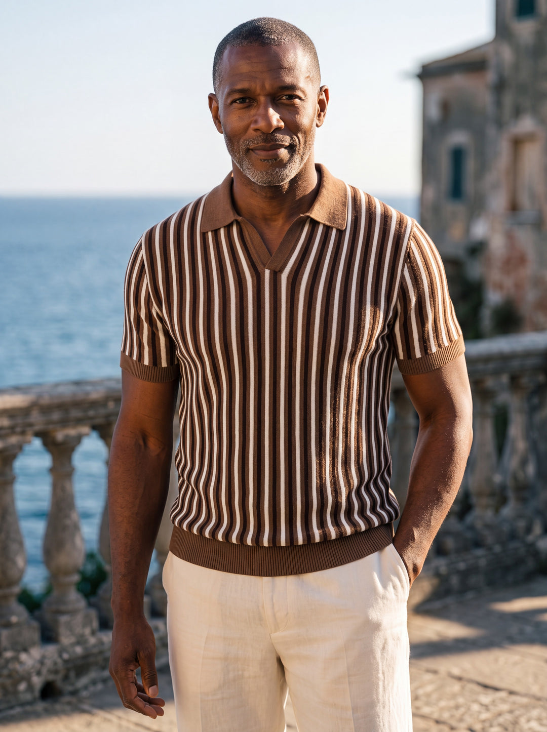 Patrick Men polo shirt in brown, worn by a model on a Mediterranean terrace - Gentlemens Manor lifestyle