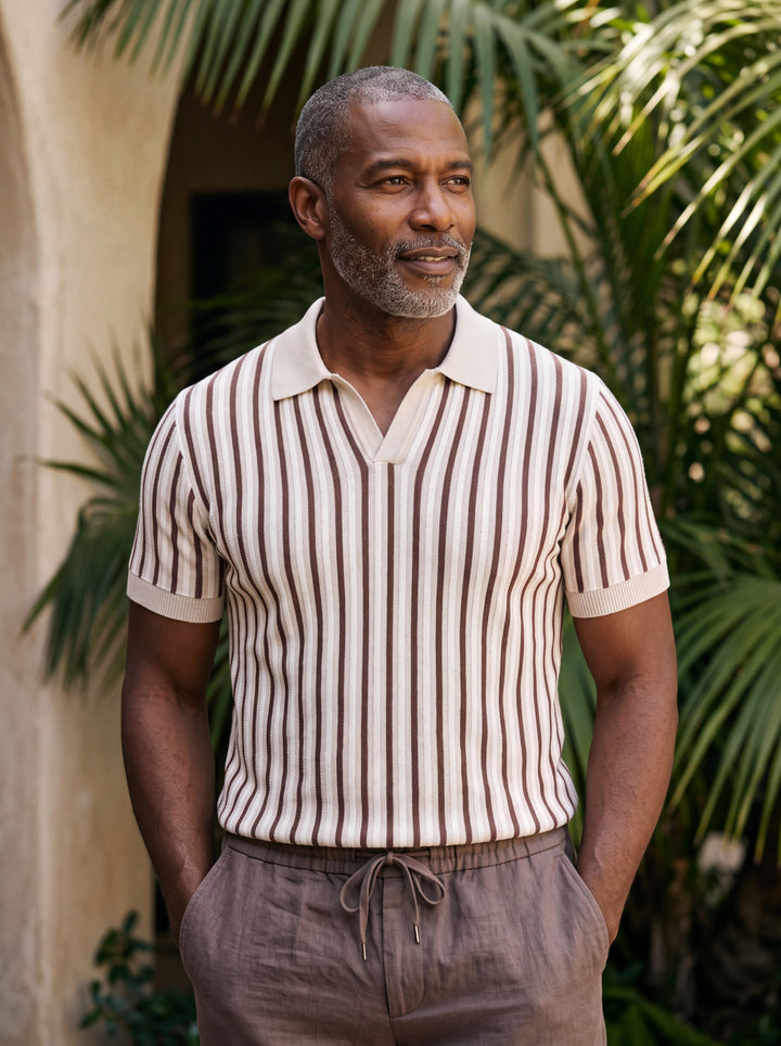 Patrick Men polo shirt in cream, worn by a model on a Mediterranean terrace - Gentlemens Manor lifestyle