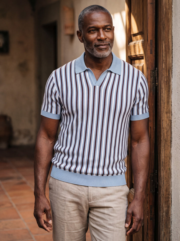 Patrick Men polo shirt in light blue, worn by a model on a Mediterranean terrace - Gentlemens Manor lifestyle