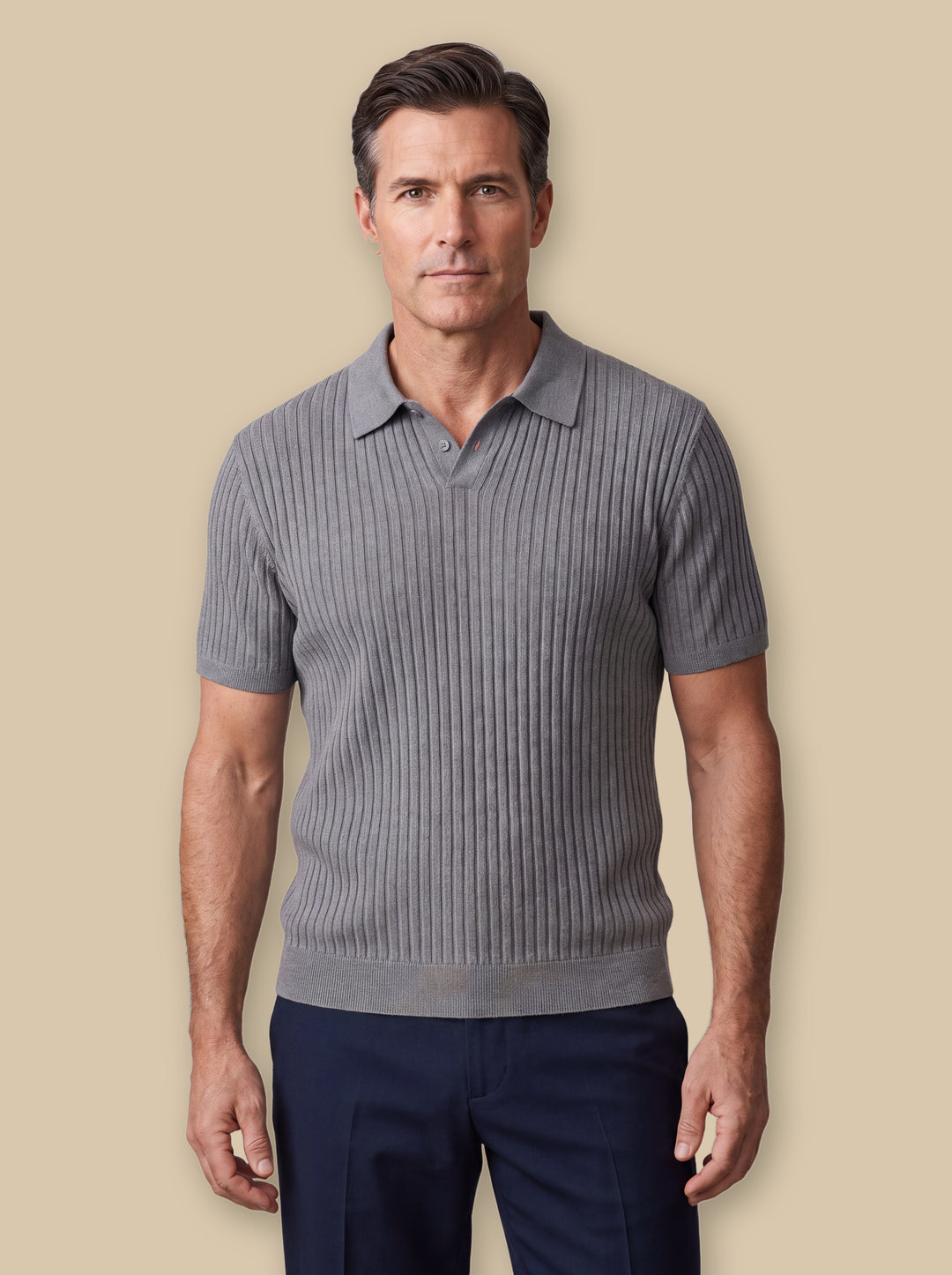 Paul polo shirt in Grey, worn by a model on a warm sand studio background - Gentlemens Manor